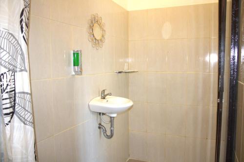 a bathroom with a sink and a shower at Joya House Uluwatu in Uluwatu