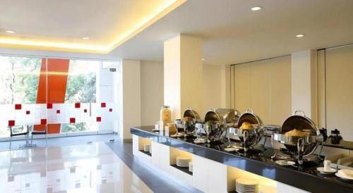 a kitchen with a counter with pots and pans at Amaris Hotel Pakuan Bogor in Bogor
