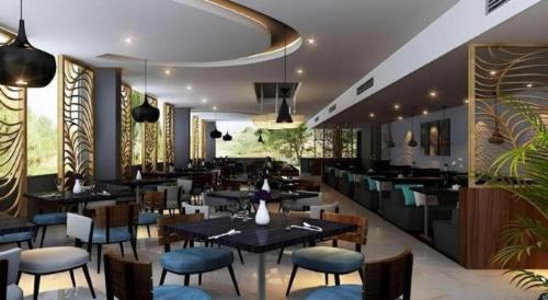 a dining room with tables and chairs in a restaurant at Bogor Valley Hotel in Bogor