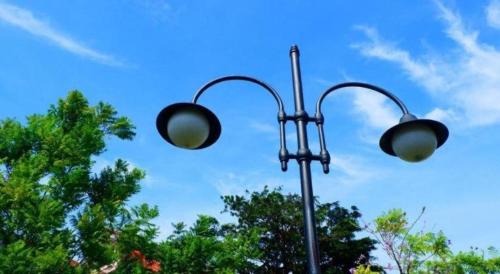 two street lights on a pole with trees in the background at Bogor Valley Hotel in Bogor