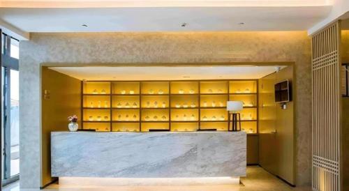 a wine tasting room with a large wall of wine glasses at Jinjiang Inn Select Kunming High-speed South Railway University Town in Kunming