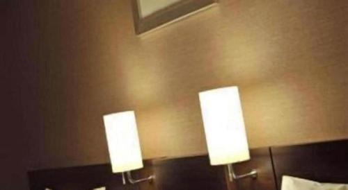 two lights on the wall of a hotel room at Daini Fuji Hotel in Nagoya