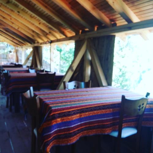a row of tables and chairs in a restaurant at Zirve Dağ Evi in Kocaeli