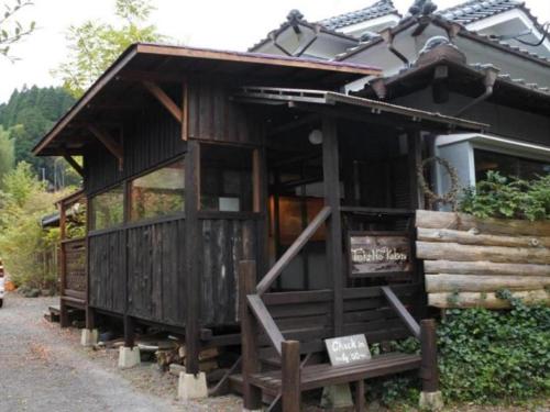 a log cabin with a sign in front of it at Secret Base Tokinokakera in Yufuin