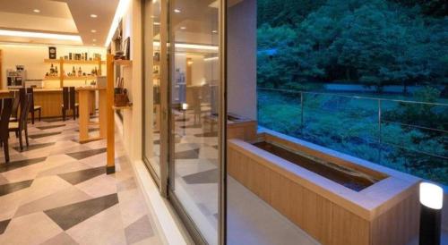 a large aquarium in the middle of a room at Hotel Myoken Tanaka Kaikan in Kirishima