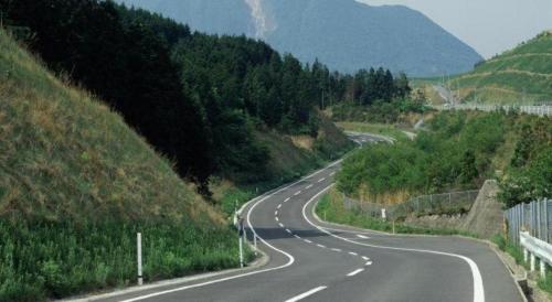 a winding road on a hill with trees at Secret Base Tokinokakera in Yufuin