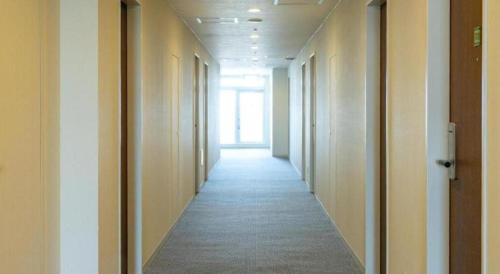 a hallway of an office building with a long corridor at Ou Hotel in Yonago