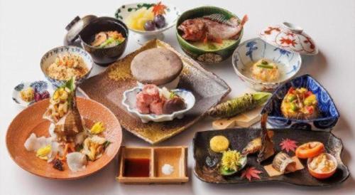 a group of plates of food on a table at Unzen Kanko Hotel in Unzen