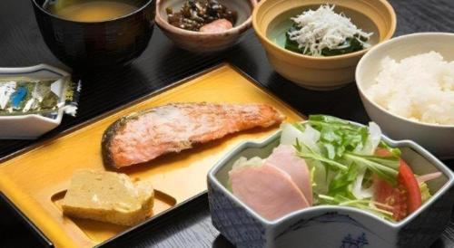 a tray with a plate of food on a table at Centia Hotel Naito in Kofu