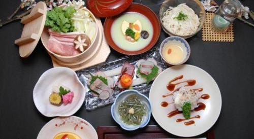 a group of plates of food on a table at Albert Hotel in Akita