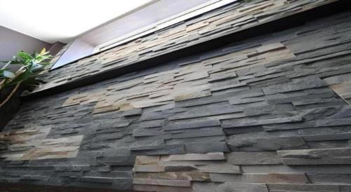 a stone wall of a house with a window at Suigetsurou Hotel in Takaoka