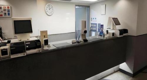 a hospital room with a counter with a tv at Alpha Hotel Tokushima in Tokushima