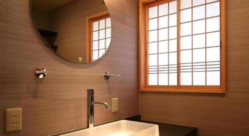 a bathroom with a sink and a mirror at Suigetsurou Hotel in Takaoka