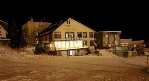 a large building is lit up at night at Espoir Misawa in Hakuba