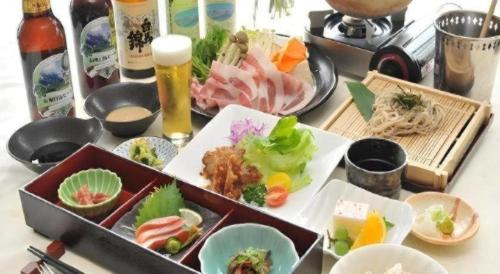 a table with plates of food on a table at Espoir Misawa in Hakuba