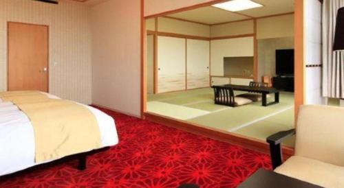 a bedroom with a bed and a large mirror at Centurion Hotel Technoport Fukui- Artificial Radium Hot Spring in Sakai