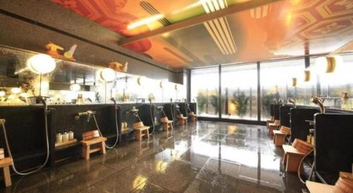 a bar with chairs in a room with a window at Centurion Hotel Technoport Fukui- Artificial Radium Hot Spring in Sakai