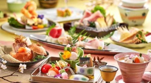 a table with several plates of food on it at Shiratamano Yu Senkei in Shibata