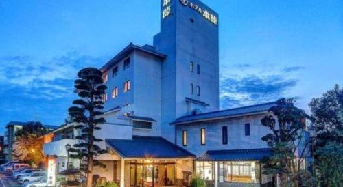 a large building with a sign on top of it at Hotel Honjin in Kumamoto
