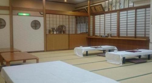 a large room with two tables in a room at Hotel Honjin in Kumamoto