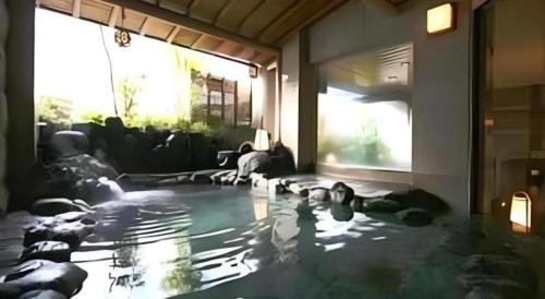 a group of dogs laying on the floor in a room at Tsukino Sumika Atami Juraku Hotel in Atami