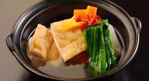 a plate of food with broccoli and other foods at Tsukino Sumika Atami Juraku Hotel in Atami