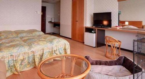 a hotel room with a bed and two chairs at Hamanako Lake Side Plaza in Hamamatsu