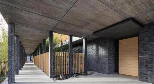 a building with a wooden ceiling and a walkway at HOTEL CLAD in Fuji