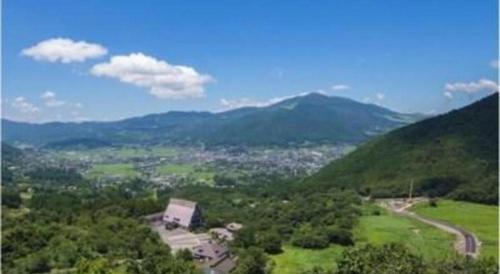 an aerial view of a valley with mountains and trees at Yufuin Onsen Yufuin Nanairo no Kaze in Yufuin