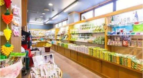 a store aisle of a grocery store with food on shelves at Yufuin Onsen Yufuin Nanairo no Kaze in Yufuin