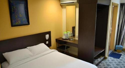Ένα ή περισσότερα κρεβάτια σε δωμάτιο στο YMCA Kuala Lumpur