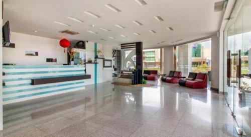 a lobby with couches and tables in a building at e Hotel in Melaka