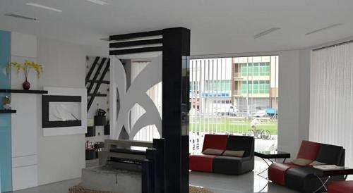 a living room with two couches and a large window at e Hotel in Melaka