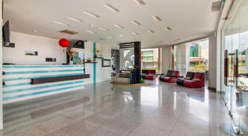 a lobby with couches and tables in a building at e Hotel in Melaka