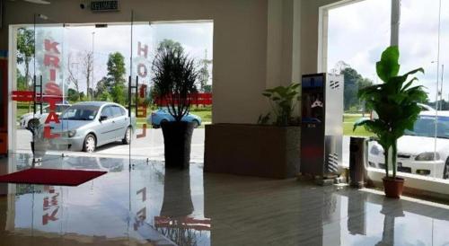 a lobby with a car parked in a parking lot at Hotel Kristal in Seri Iskandar