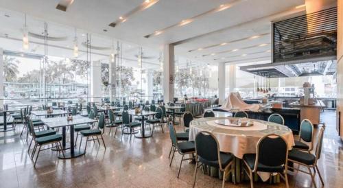 a restaurant with tables and chairs in a room at RH Hotel Sibu in Sibu