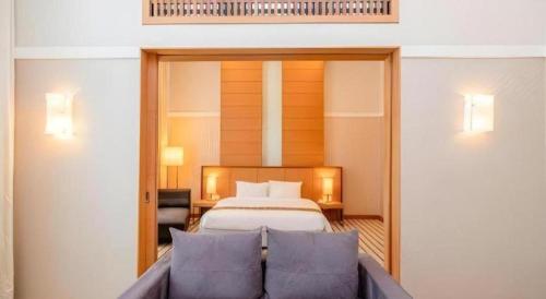 a hotel room with a bed and a couch at RH Hotel Sibu in Sibu