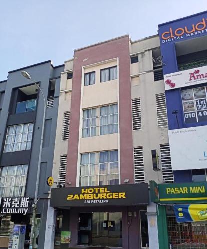 a building on a city street with buildings at Hotel Zamburger Sri Petaling in Kuala Lumpur
