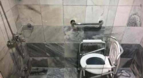 a bathroom with a toilet in a stall at Pelican Hotel in Batu Pahat