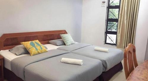 a bedroom with a large bed with two pillows at Sherrinton Hotel in Mentekab