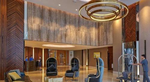 a lobby with chairs and a chandelier in a building at Hatten Place Melaka in Melaka
