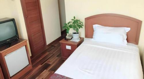 Postel nebo postele na pokoji v ubytování Global Hotel Labuan