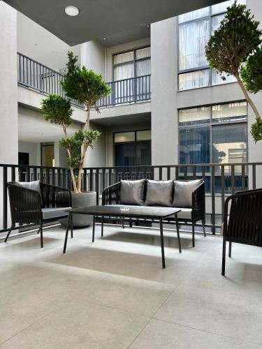 a group of benches sitting in front of a building at 2BHK Serenity Suite By SkyPark One in Islamabad
