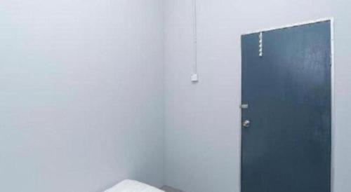 a blue door in a room with a wall at SPOT ON 89757 The Rooms JB in Johor Bahru