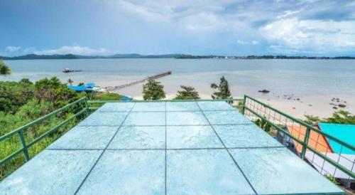 a view of the beach from the balcony of a house at Dreamland Beach Holiday in Kudat
