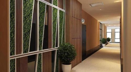 a hallway with a green wall in a building at S Hotel in Johor Bahru