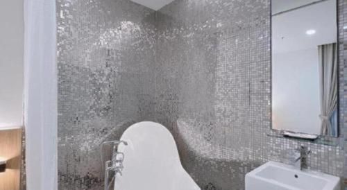 a bathroom with a toilet and a sink and a tub at S Hotel in Johor Bahru