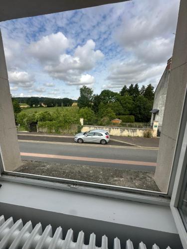 a view from a window of a car on a road at Normandy suites in Igé