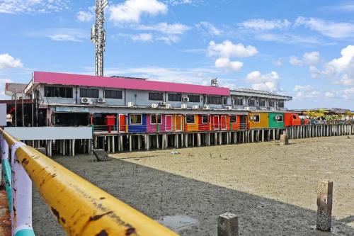 a building with a colorful building with a fence at OYO 90474 Skycity Motel in Klang