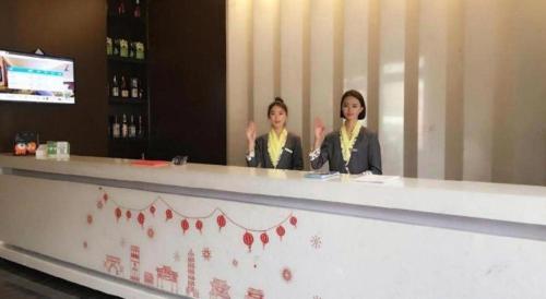 two women sitting at a counter in a restaurant at Zmax Changzhi Bayi Square in Changzhi